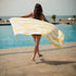 A girl holding a a Quick Dry, Sand Free, Light Weight, Compact and Ecofriendly Microfiber Beach Towel from La Toalla