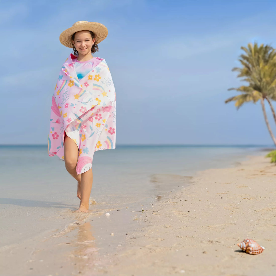 A girl wrapped in a Quick Dry, Sand Free, Light Weight, Compact and Ecofriendly Microfiber Beach Towel from La Toalla with kids design