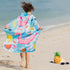 A girl wrapped in a kids designed Quick Dry, Sand Free, Light Weight, Compact and Ecofriendly Microfiber Beach Towel from La Toalla