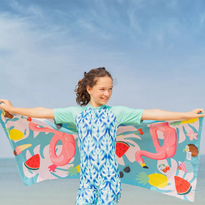 A girl holding a kids Quick Dry, Sand Free, Light Weight, Compact and Ecofriendly Microfiber Beach Towel from La Toalla